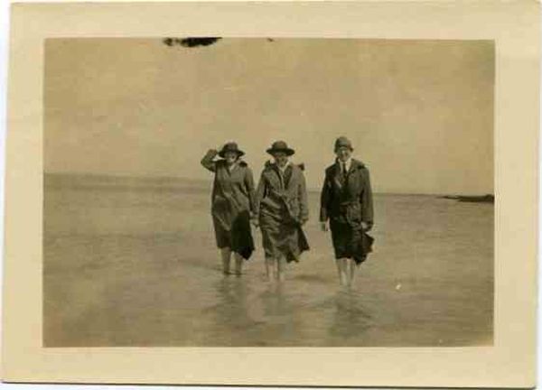 Army female nurses walking barefoot in low water during WWI
