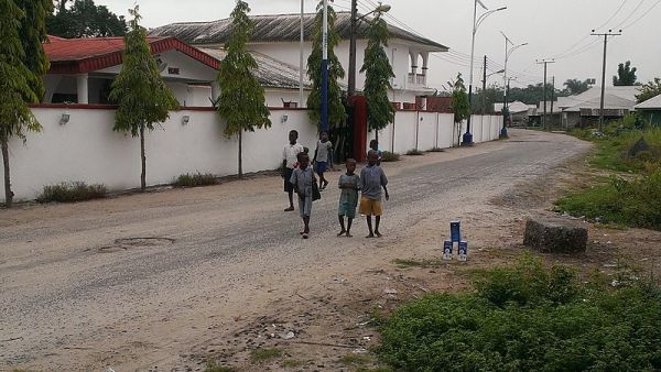 Happy children walking barefoot to school in Ilaje, Ondo state, Nigeria