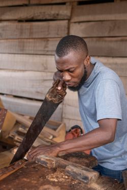 unemployed graduate working with hand saw